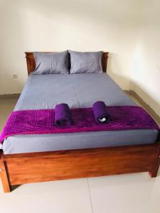 A bed or beds in a room at Calliandra Homestay