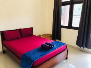 A bed or beds in a room at Calliandra Homestay