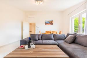 een woonkamer met een bank en een tafel bij Paramount Apartments in Dugi Rat