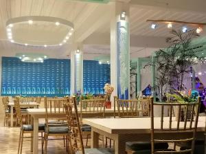 a dining room with tables and chairs and a blue wall at Casa Pilar Beach Resort in Boracay