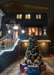 a christmas tree in front of a building with lights at Hostel 211A in Almaty