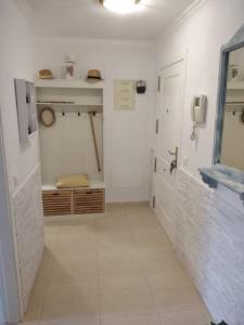 a bathroom with a toilet and a phone on the wall at Apartment Mar Augusta in Calpe