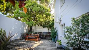 a bench sitting in the courtyard of a house at House of Grace Apt in East London