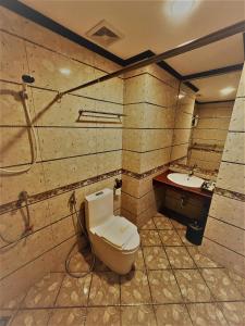 a bathroom with a toilet and a sink at VANHSENG BOUTIQUE VIENTIANE HOTEL in Vientiane