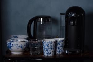 a coffee maker and cups on a table at Stone Court House in Maidstone