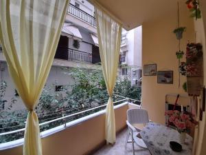 a room with a window with a view of a balcony at Sweet Home in Thessaloniki