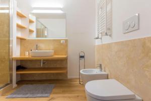 a bathroom with a toilet and a sink at La Dolce Vita - Luxury Stylish Flats in Trastevere 70-90sqm in Rome