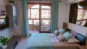 a bedroom with a bed and a large window at Grace resident stúdió apartman in La Mata +57 photos