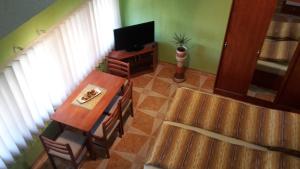 A television and/or entertainment centre at Nefelejcs Apartman