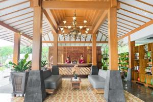 a lobby of a store with couches and a chandelier at Burza Hotel Yogyakarta in Yogyakarta
