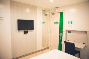 a room with a flat screen tv on the wall at Go Hotels Ortigas Center in Manila
