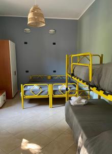 a room with three bunk beds and a lamp at Ostello Fiume Tirino in Bussi sul Tirino