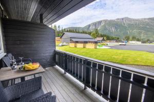 a balcony with a table and a view of a mountain at Topcamp Mosjøen - Helgeland in Mosjøen