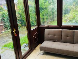 a room with a chair in front of a window at Bull, 3 bedroom House with Garden and Free Car Park in Stifford