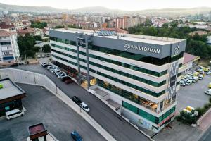 a large building in a city with a parking lot at Park Dedeman Elazığ in Elazığ