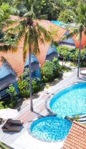 an aerial view of a resort with two pools and palm trees at The MG Villa & SPA in Nusa Penida