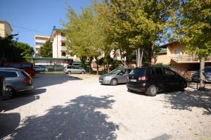 a group of cars parked in a parking lot at Appartamenti Foyer in Bibione +6 photos