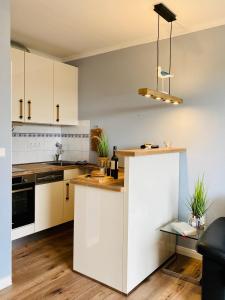 a kitchen with white cabinets and a counter top at Mein Lieblingsplatz (App.21) in Sankt Peter-Ording