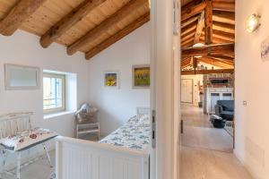 a bedroom with a bed in a room with wooden ceilings at Dori’s Home , romantico loft in Maser