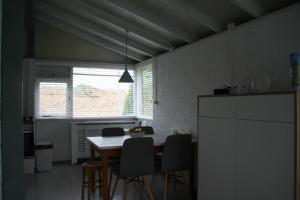 a kitchen with a table and chairs in a room at Rekerlanden 90 in Schoorldam