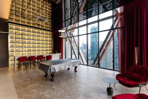 a room with a table and chairs and a large window at Scarletz KLCC Studio Suites 4 pax Luxury Modern Style WiFi 100Mbps in Kuala Lumpur +98 photos