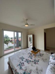 a bedroom with a bed with a laptop on it at Home Office,Whitefield, ITPL in Bangalore