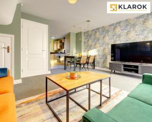 a living room with a tv and a table at LARGE 4 Bedroom Semi-Detached House Sleeps 7 By Klarok Short Lets & Serviced Accommodation in Peterborough