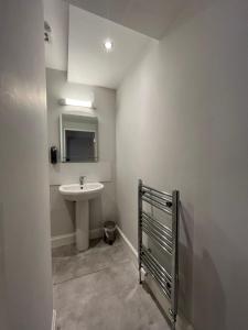 a bathroom with a sink and a mirror at Park View Rooms in Edinburgh