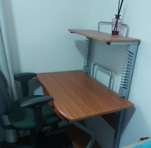 an office desk with a chair and a desk and shelves at Cascabelbnb Private 2BR apartment in Noarlunga +13 photos