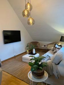 a living room with a couch and a tv at Fully Equipped Home Close to Malmö & Copenhagen in Vellinge