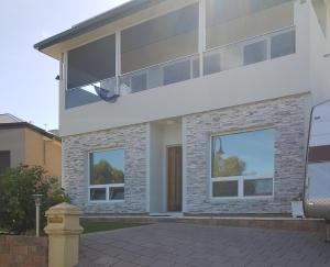 a house with a basketball hoop in front of it at Cascabelbnb Private 2BR apartment in Noarlunga