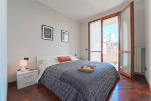 1 dormitorio con cama y ventana grande en Incantevole appartamento a Gaggiano sul Naviglio!, en Gaggiano