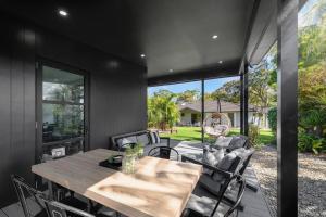 a dining room with a table and chairs at Two Dreamy Properties In One in Culburra Beach