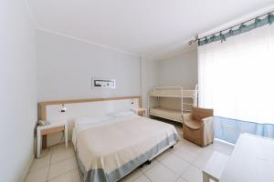 Ein Bett oder Betten in einem Zimmer der Unterkunft Hotel Fontane Bianche