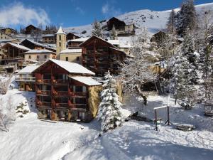 a lodge in the snow with snow covered trees at Les Chalets du Villard in Saint-Véran