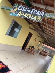 a building with a sign hanging from the ceiling at Casa de férias Amarela em Prado in Prado