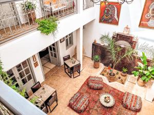an overhead view of a balcony with a table and chairs at Riad Dar Chadia in Marrakesh