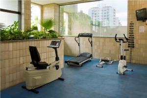 a gym with several exercise machines in a room at Apart Hotel Volpi in Belo Horizonte