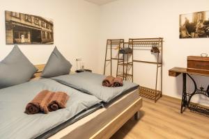 a bedroom with a bed with towels on it at Hotel Alte Färberei in Goslar