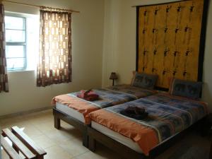 a bedroom with a large bed with two animals on it at Okambishi's Rest in Usakos