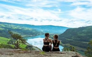 two girls in bikinis sitting on a rock overlooking a river at Topcamp Rustberg - Hafjell in Hafjell