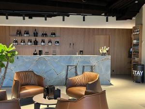 a lobby with two chairs and a counter with wine bottles at STAY Nordhavn in Copenhagen