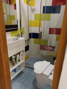 a bathroom with a shower and a toilet and a sink at Martim Moniz 28 Guest House in Lisbon