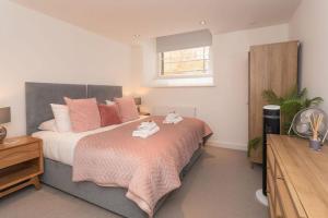 a bedroom with a bed with two towels on it at Panda Sanctuaries, Kensington Chapel Apartment in Bath