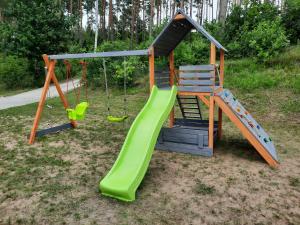 a playground with a slide and a swing at LAKE VIEW Apartamenty in Brodnica