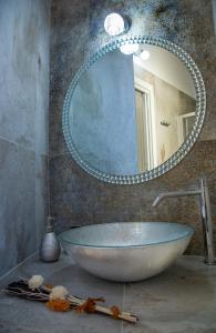 a bathroom with a sink with a large mirror at La Perla della Cattedrale luxury home in Agrigento