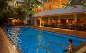 a man sitting in a swimming pool in a building at Park Plaza Chennai OMR in Chennai