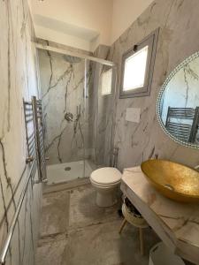 La salle de bains est pourvue d'un lavabo, de toilettes et d'une baignoire. dans l'établissement La Perla della Cattedrale luxury home, à Agrigente