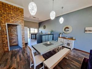 a dining room with a table and chairs at Dullstroom Manor Game & Trout Lodge in Dullstroom