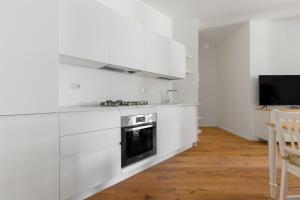 a kitchen with white cabinets and a stove at La Dolce Vita - Luxury Stylish Flat in Trastevere 60sqm in Rome